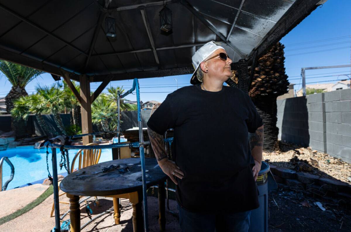 Lilac Shabtai surveys fire damage, due to fireworks, to her family's home, along with a next do ...