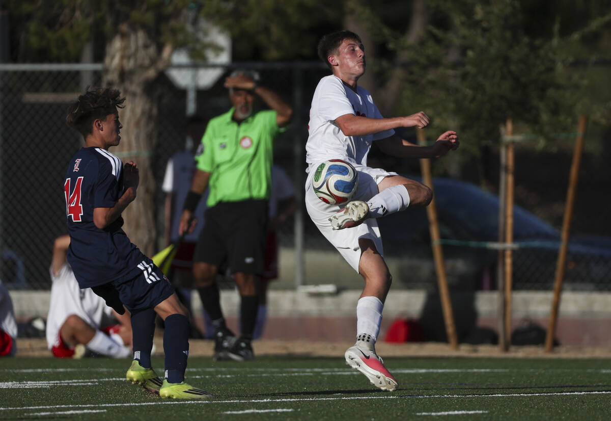 Arbor View's Hayden Braswell (38) redirects the ball under pressure from Liberty's Gr ...