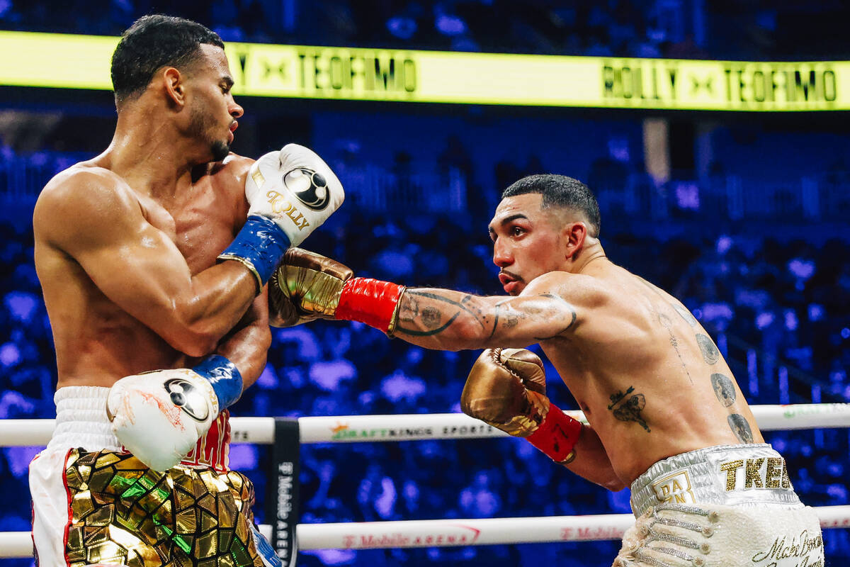 Teofimo Lopez, right, throws a punch at Rolly Romero during a boxing bout at T-Mobile Arena Sat ...