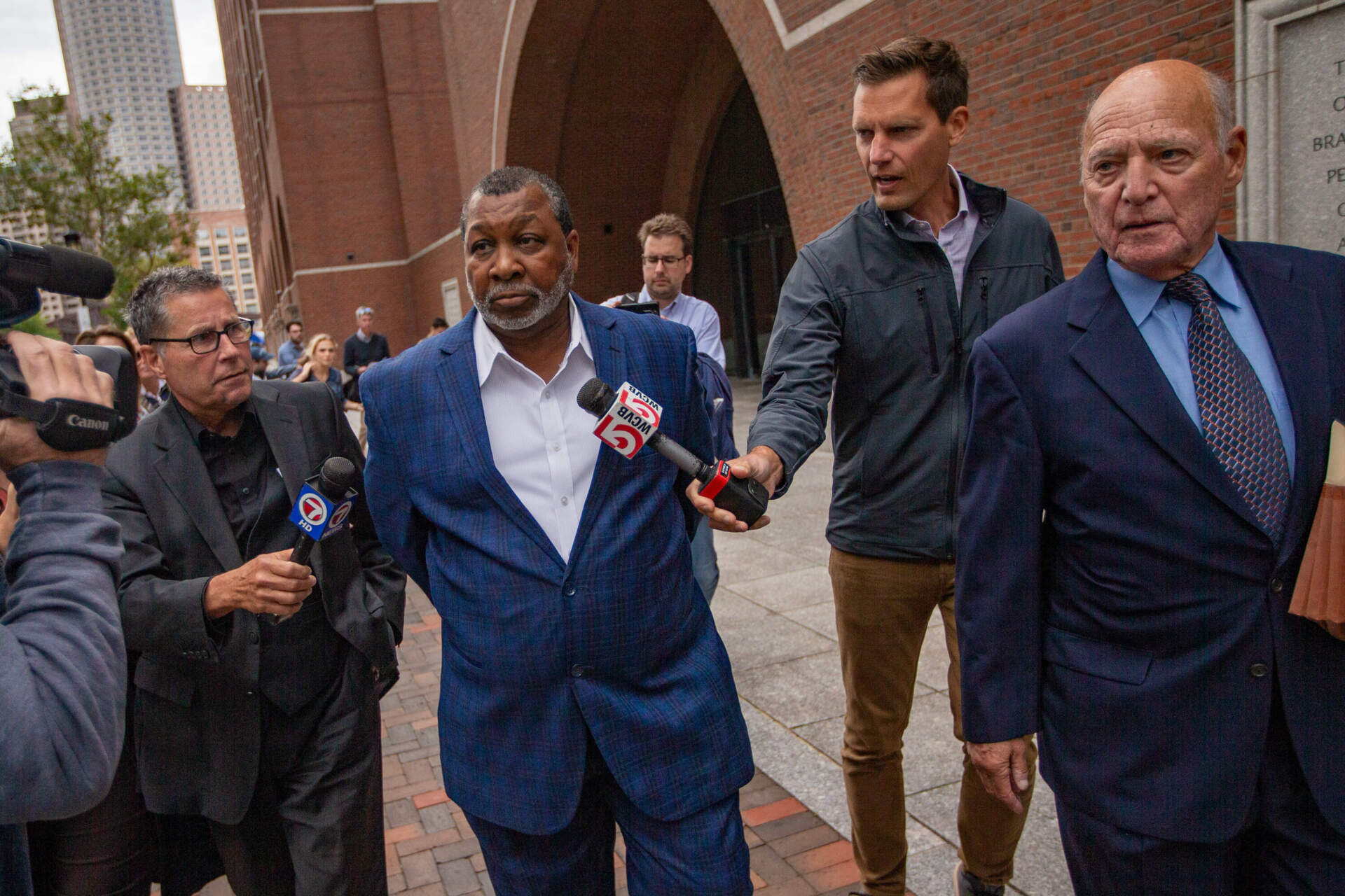 Suffolk County Sheriff Steven Tompkins walks with his defense attorney Martin Weinberg as they leave after his indictment at the Moakley Federal Courthouse. (Jesse Costa/WBUR)
