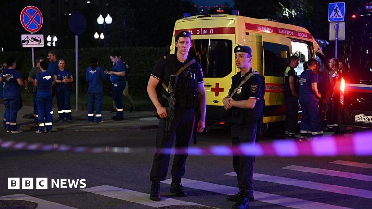 Armed Moscow police stand guard in front of an ambulance near the scene of an explosion near the centre of the city.