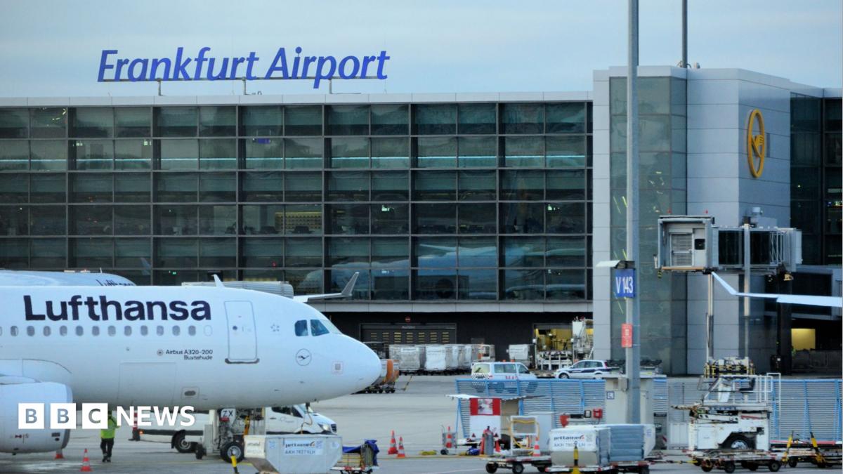 A view of a taxiing area at Frankfurt Airport. A Lufthansa plane sits on the tarmac.