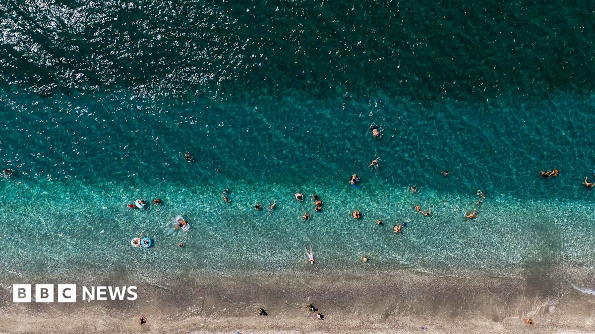 Aerial view of strip of beach in Greece and ocean