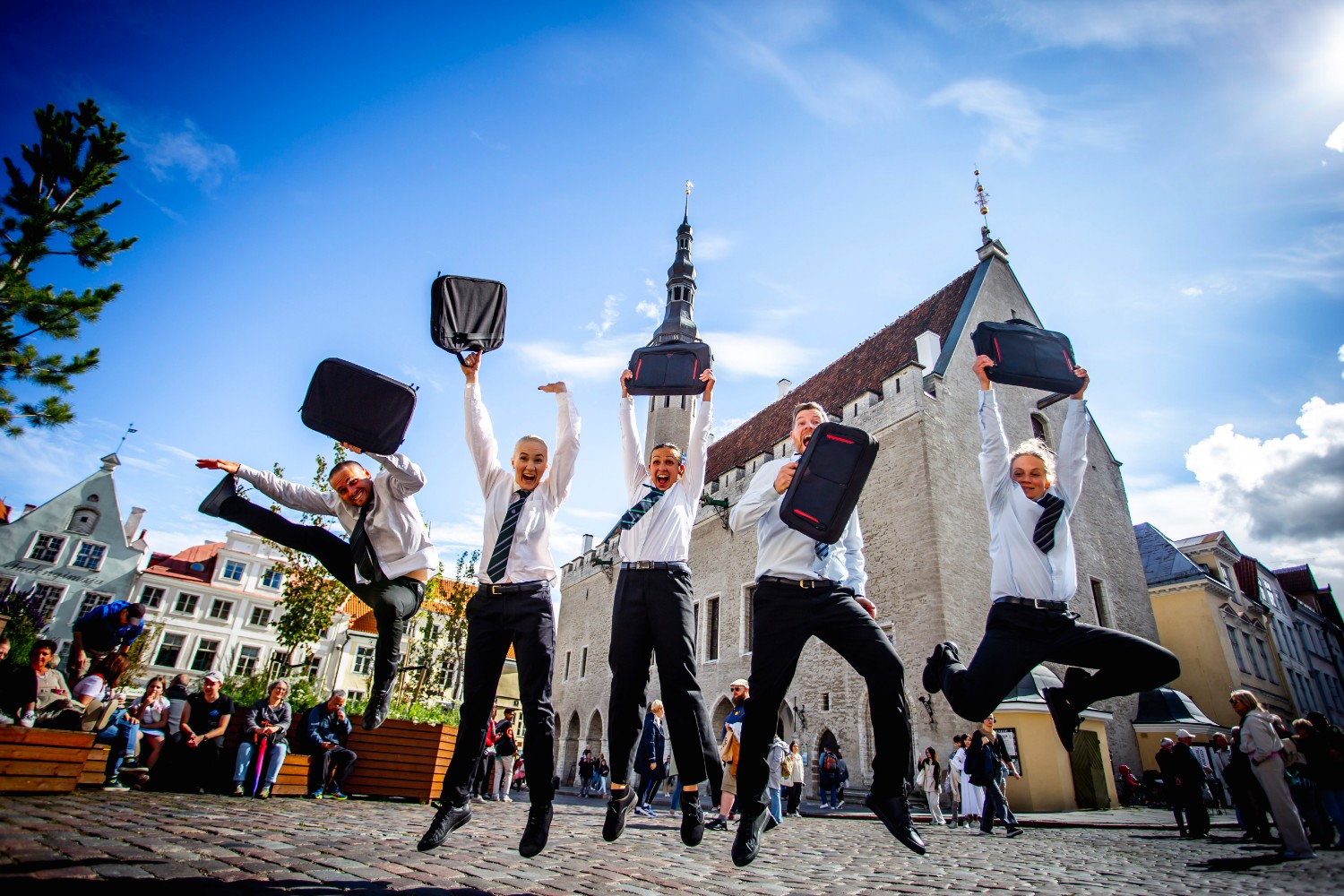 Performers leap into the air during a street theatre show outside Tallinn Town Hall as part of Tallinn Fringe Festival. Photo by Anton Serdjukov.