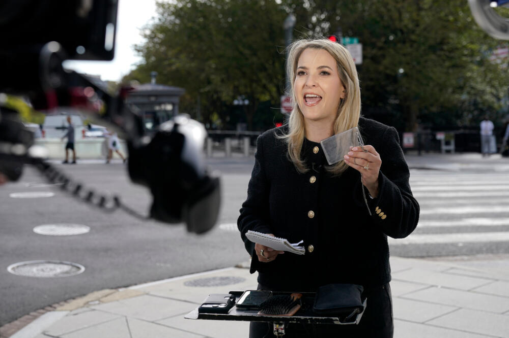 CNN Senior White House Reporter Betsy Klein, holding up an empty credential holder, reports near the White House complex after having her credential confiscated following President Donald Trump's ban on CNN, MS NOW and Politico, Saturday, Sept. 19, 2026, in Washington. (AP Photo/Jose Luis Magana)