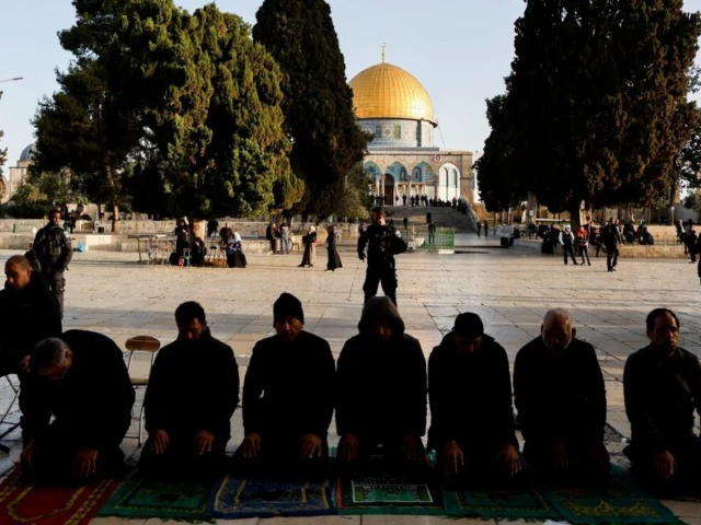 palestinian men pray at al aqsa mosque also known to jews as the temple mount as israeli security forces take position at the compound while tension arises during clashes with palestinians in jerusalem s old city april 5 2023 reuters