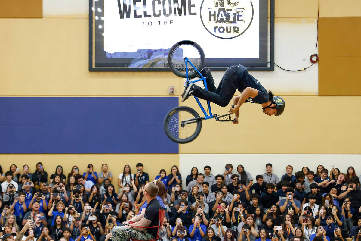 BMX rider Oscar Marquez jumps over Veterans Tribute Career and Technical Academy teacher, Tyler ...
