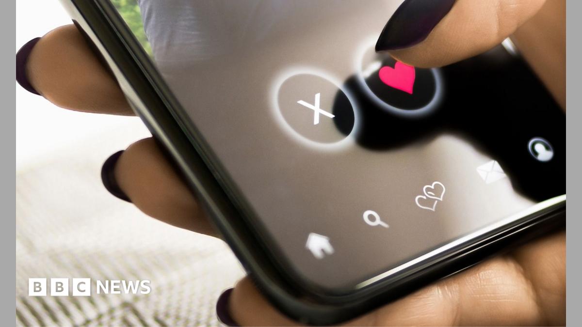 A woman with black painted nails presses a heart on a mobile phone