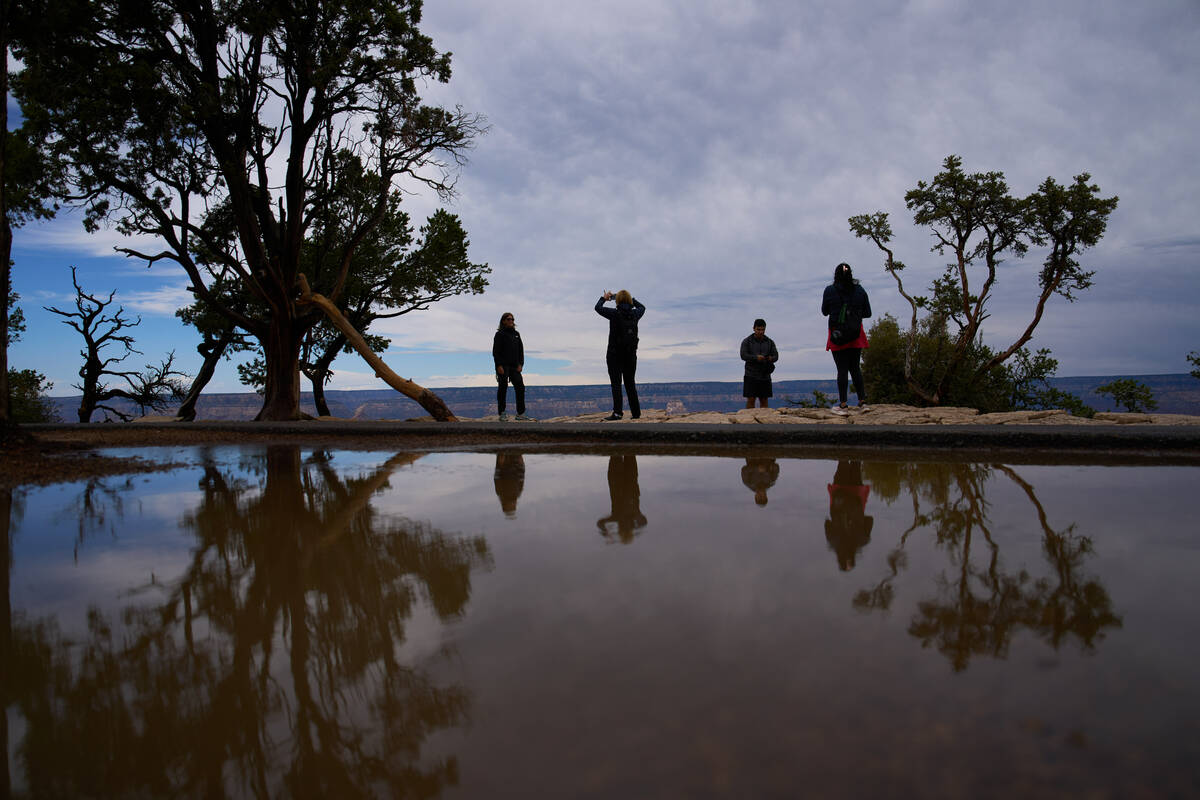 People stand at the rim of the Grand Canyon, Monday, Aug. 31, 2026, in Grand Canyon National Pa ...