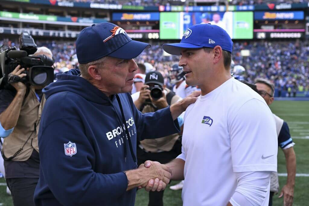 Head coach Sean Payton of the Denver Broncos and head coach Mike Macdonald of the Seattle Seahawks shake hands after the game at Lumen Field on September 8, 2024 in Seattle. (Alika Jenner / Getty Images / The Athletic)