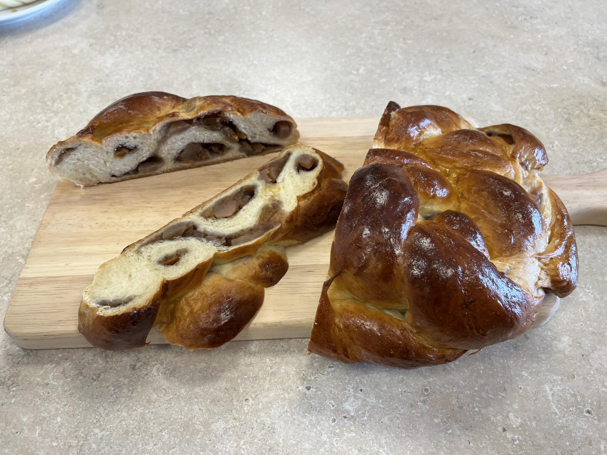 Mandy Silverman of Sharon, known online as Mandylicious, braids apple-stuffed challah in the WBUR kitchen. (Lynn Jolicoeur/WBUR)