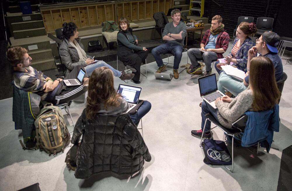 BU professor of the practice of playwriting Kate Snodgrass observes as writer Ronan Noone leads a class at the Playwrights' Theatre in Boston in 2016. (Robin Lubbock/WBUR)