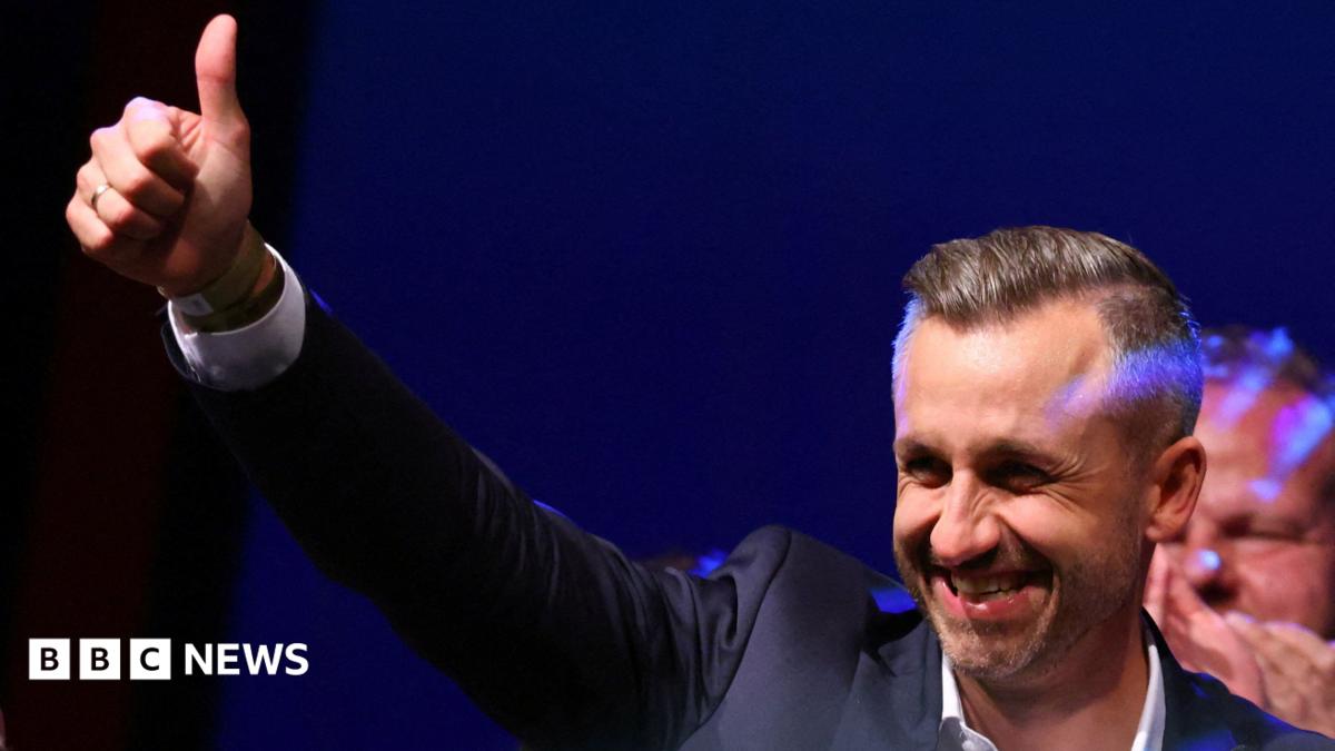 Ulrich Siegmund, leader of the AfD in the state, raises a thumbs up at the election party.