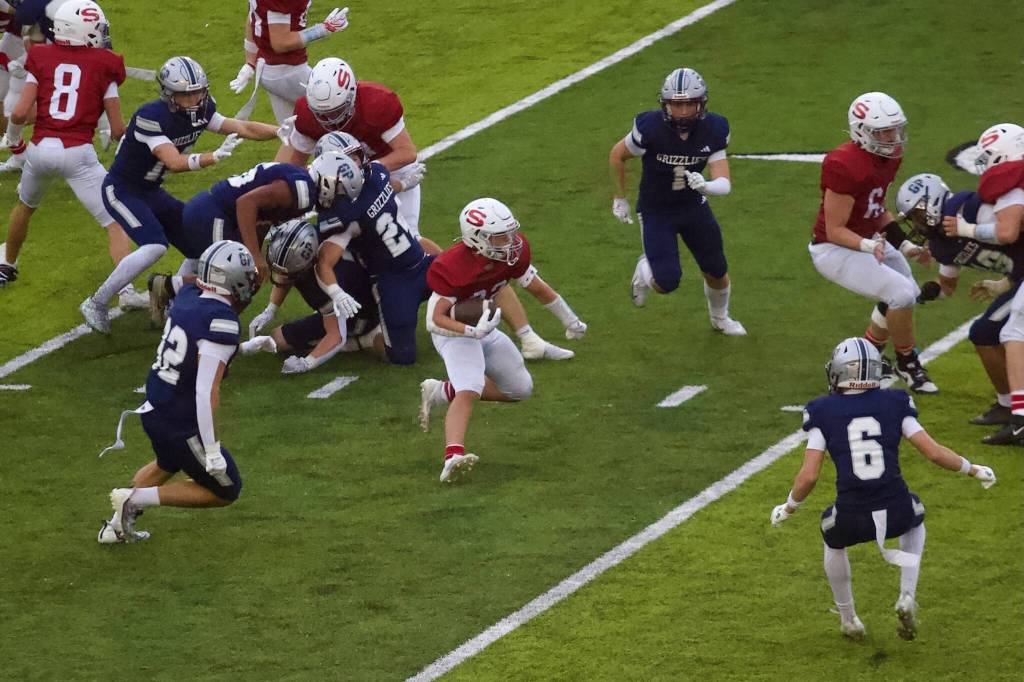 Snohomish junior Bryson Acosta navigates his way up the field as a trio of Glacier Peak defenders close in during the Panthers’ 38-21 loss to the Grizzlies at Veterans Memorial Stadium on Sept. 11, 2026. (Joe Pohoryles / The Herald)