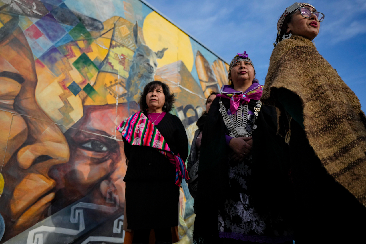 Mapuche Indigenous women prepare to commemorate the National Day of Indigenous People as part of celebrations of "We Tripantu," the Mapuche new year coinciding with the winter solstice in the Southern Hemisphere, at the Original People's Ceremonial Park in Santiago, Chile, Monday, June 2023. Image by: AP Photo/Esteban Felix.