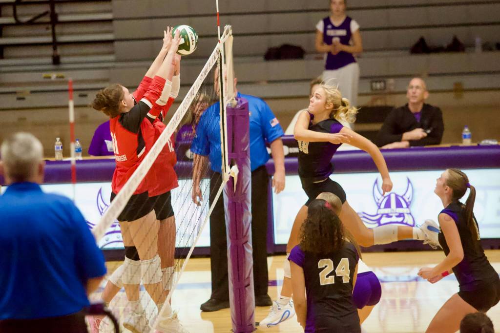 Snohomish junior Carly McIver (11) and freshman Brooklyn Beverford rise to block a ball sent over by Lake Stevens junior Tatum Lewis in the Panthers’ 3-0 loss to the Vikings at Lake Stevens High School on Sept. 8, 2026. (Joe Pohoryles / The Herald)