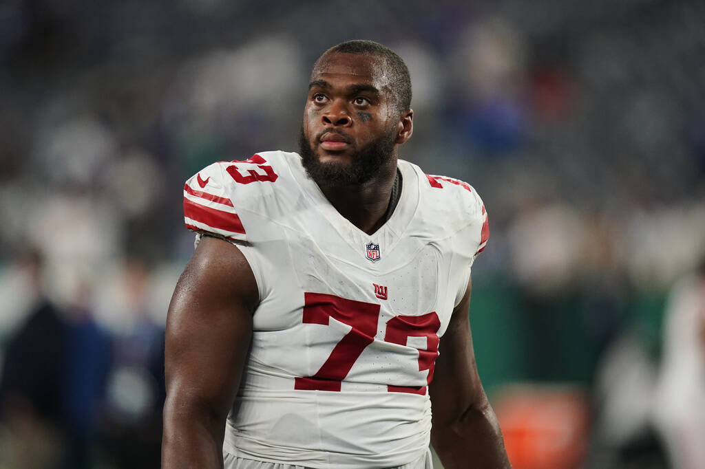 New York Giants offensive lineman Evan Neal (73) walks off the field after an NFL preseason foo ...