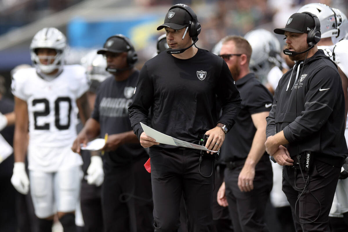 Raiders head coach Klint Kubiak looks on from the field during team warm ups before an NFL game ...