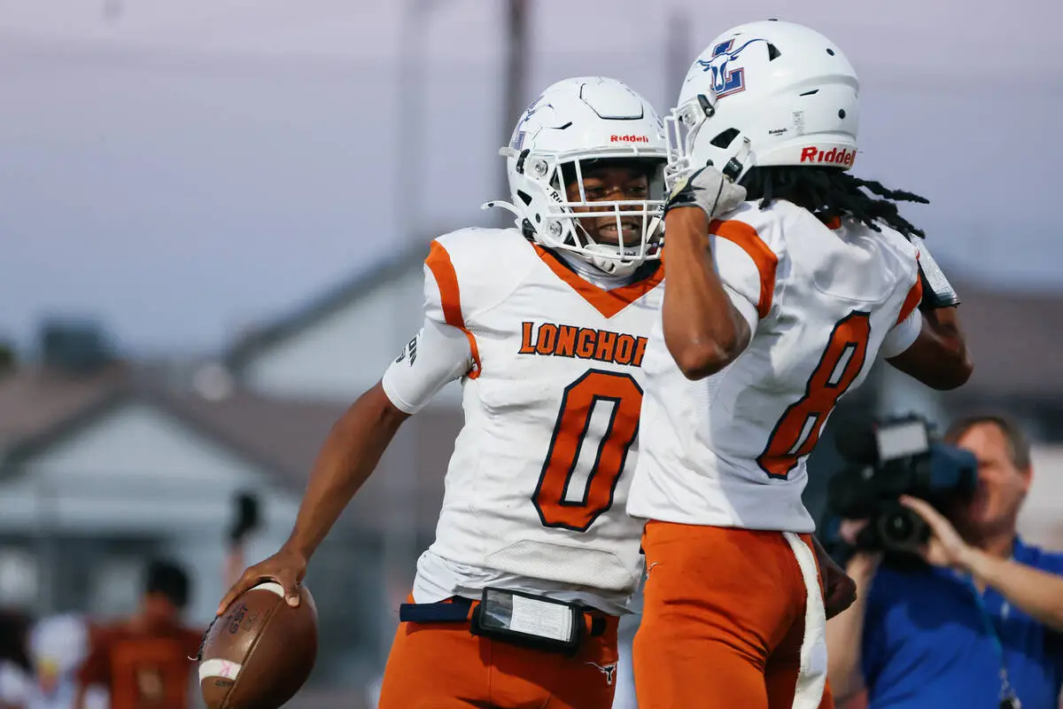 Legacy halfback Cameron Turner (0) celebrates with Legacy wide receiver Dayshawn Bucklew (8) af ...