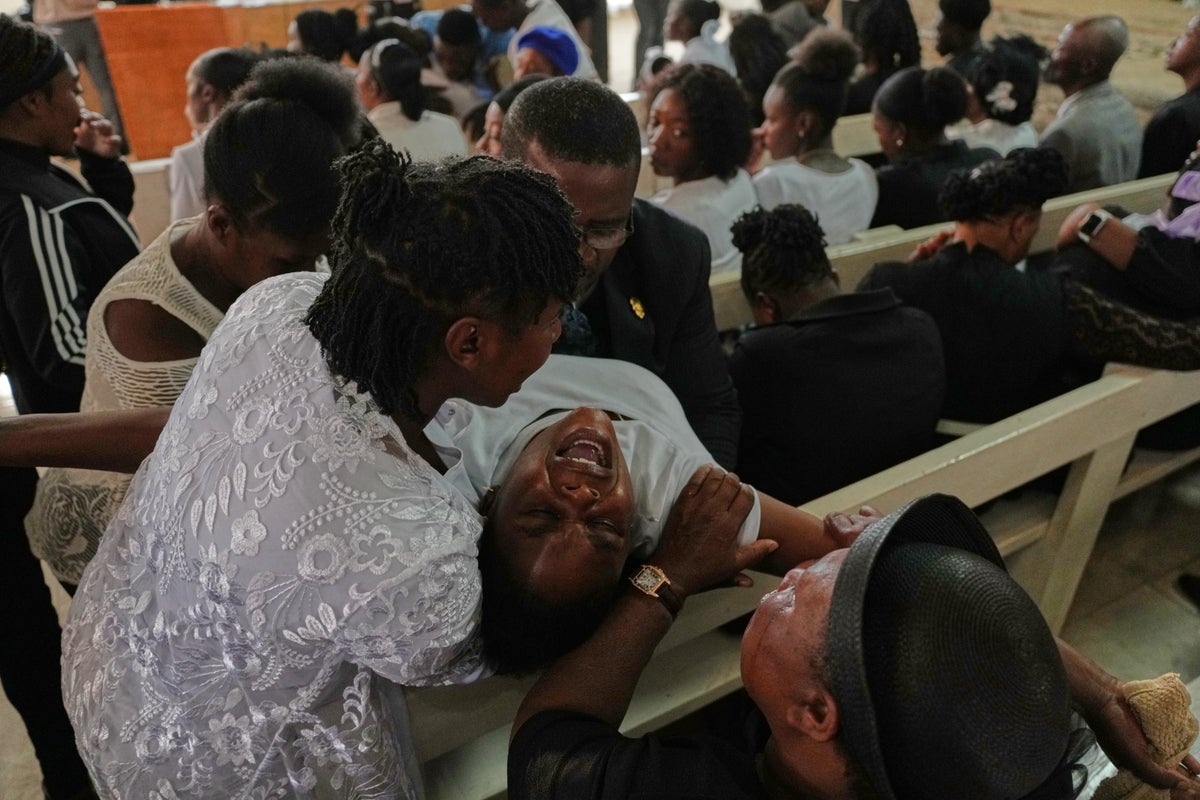 Mourners file into a church in Haiti where gangs killed dozens of people in latest rampage