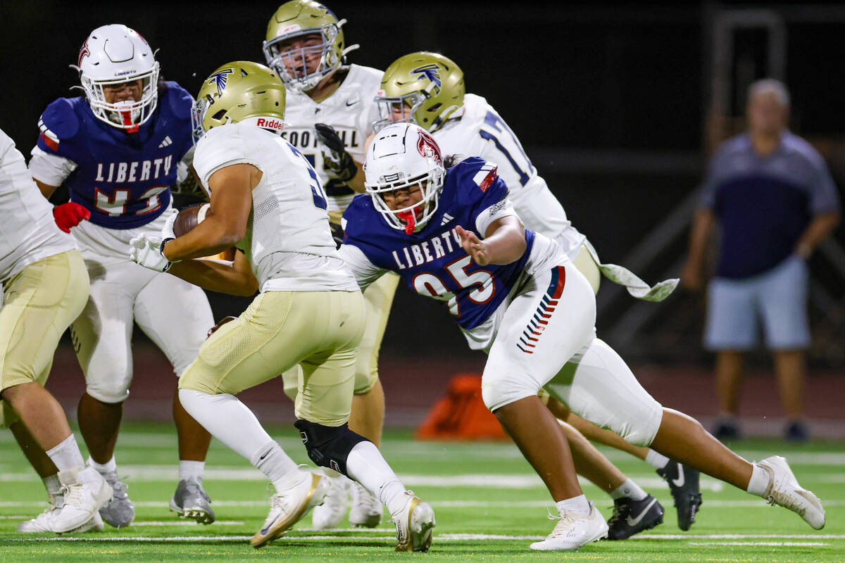 Foothill running back Anthony Taylor (3) is pursued by Liberty defensive tackle Iese Sauvao (95 ...