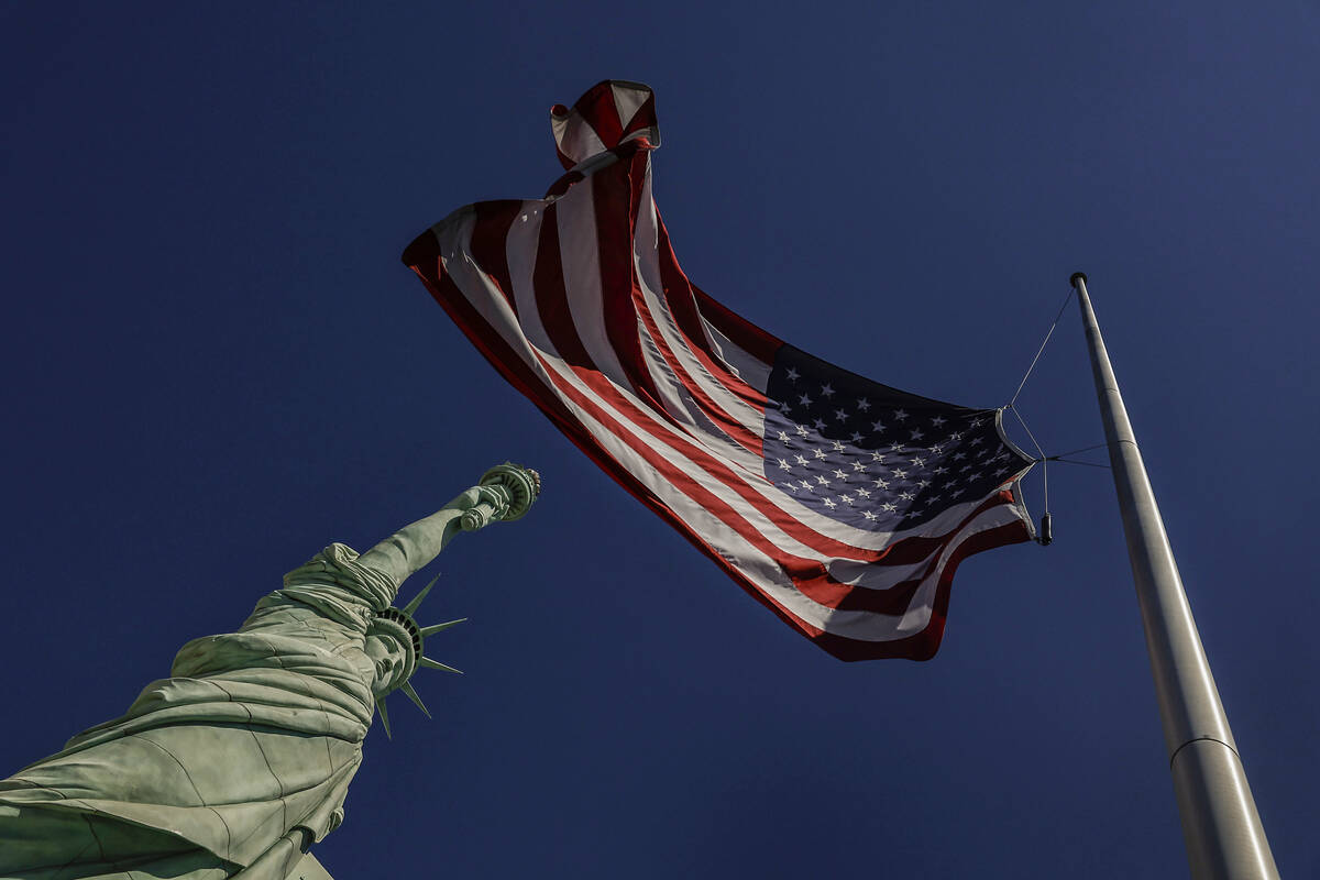 The America flag and New York-New-York’s replica Statue of Liberty are photographed duri ...