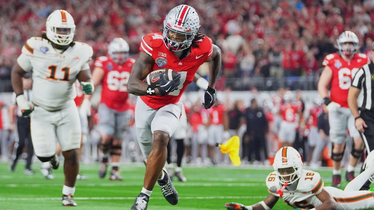Ohio State wide receiver Jeremiah Smith, center, gets away from Miami defensive lineman David Blay Jr. (11) and defensive back Ja'Boree Antoine (16) to score a touchdown on a pass from quarterback Julian Sayin, not visible, during the second half of the Cotton Bowl College Football Playoff quarterfinal game Wednesday, Dec. 31, 2025, in Arlington, Texas.