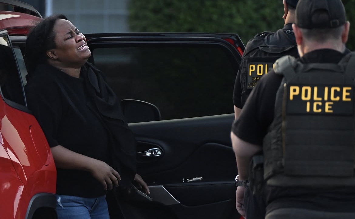 Patricia Pierre-Louis (in black) weeps while watching her neighbors and co-workers being detained in Springfield, Ohio, on Thursday, Aug. 27, 2026. Courtesy photo by Carol Guzy, used with permission.