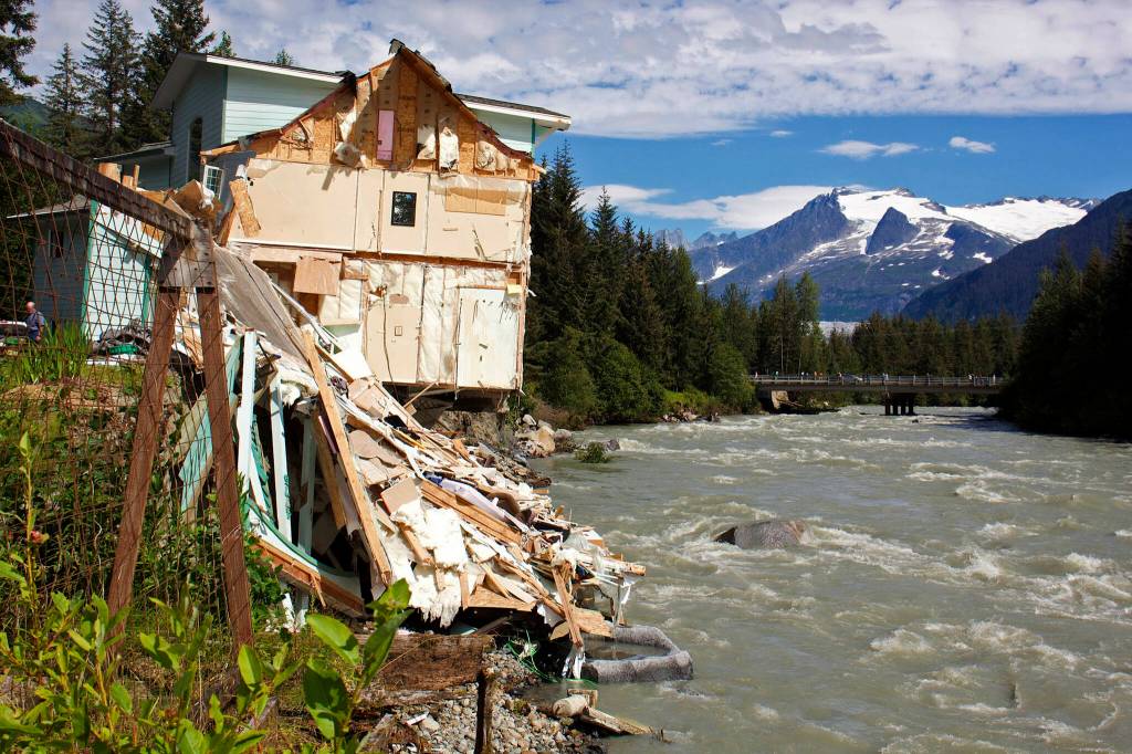 Debris from a home that partially fell into the Mendenhall River sits on the riverbank on Aug. 6, 2023. Dozens of homes were damaged or destroyed by the flooding. (Mark Sabbatini / Juneau Empire file photo)