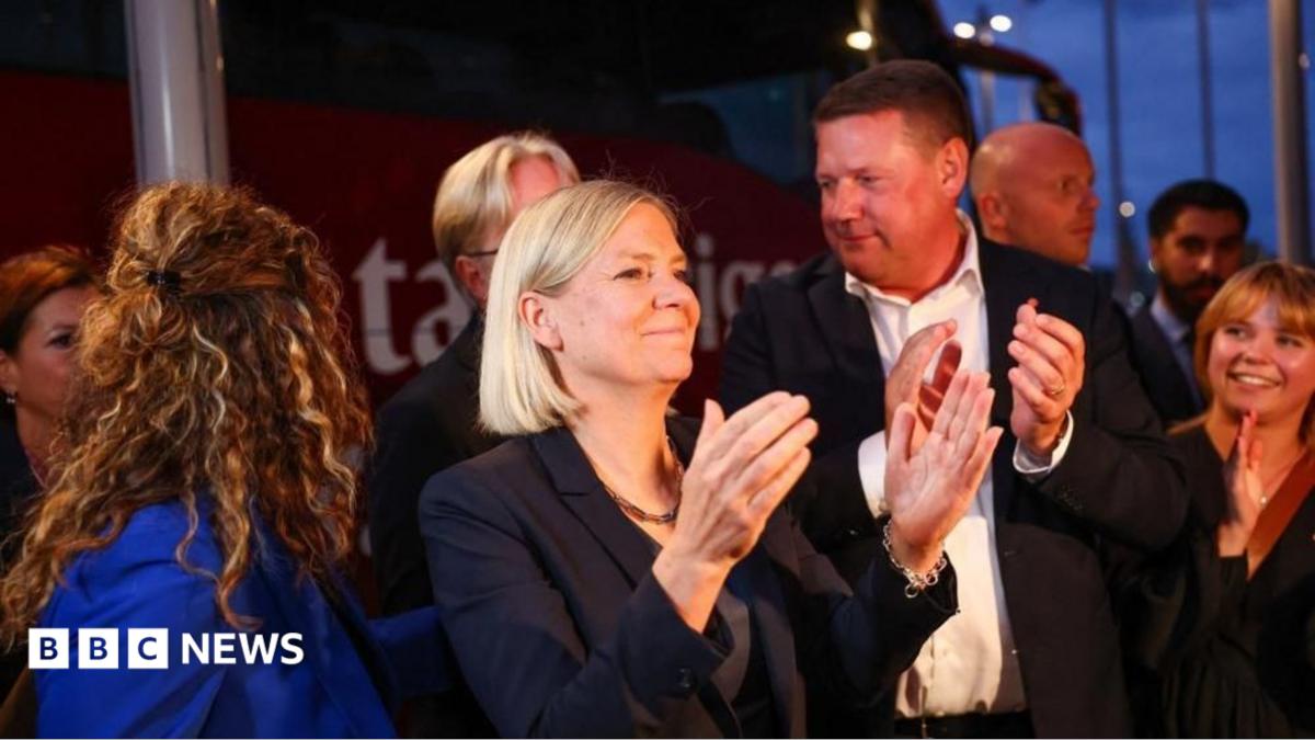 Sweden's Social Democratic Party leader, Magdalena Andersson applauds as she waits with other party members for general election results