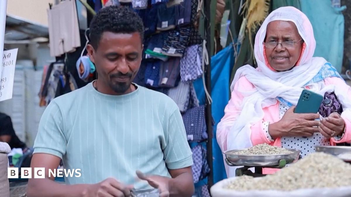 A market seller packing food for the buyer