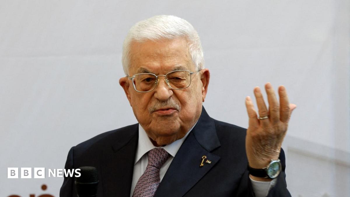 Mahmoud Abbas, wearing a suit, speaks into a microphone.
