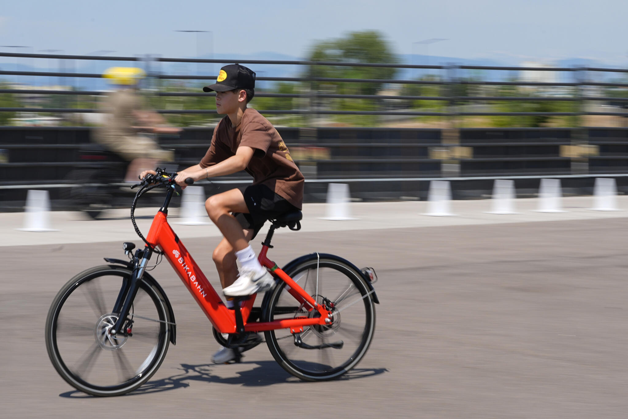 A visitor guides an electric bicycle around a test track at the Electrify Expo, Sunday, July 14, 2024, in north Denver. (David Zalubowski/AP)