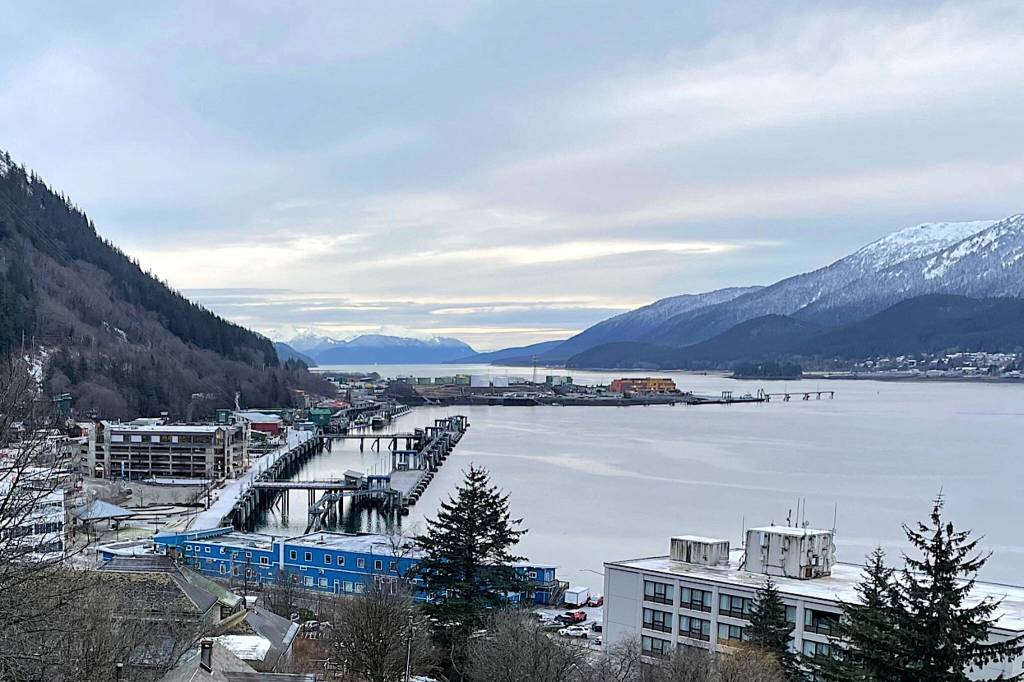 Looking south from downtown Juneau, with buildings and docks in the foreground, the rock dump can be seen jutting into Gastineau Channel and providing a weather-protected harbor for Juneau. (Laurie Craig/Juneau Empire file photo)