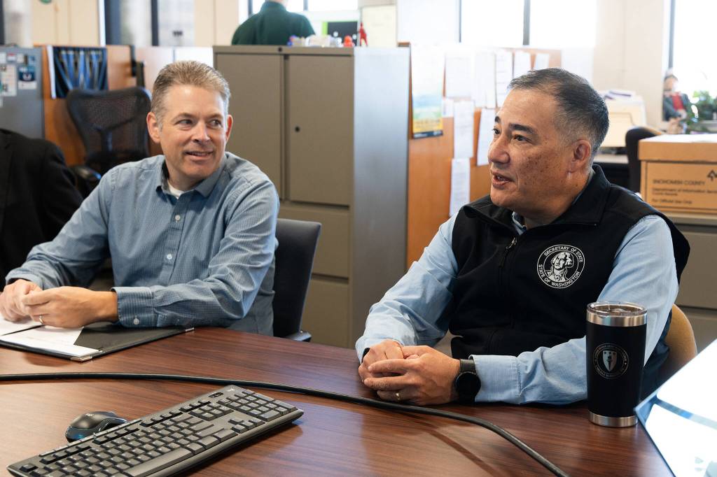 Washington Secretary of State Steve Hobbs, right, meets with Snohomish County Auditor Garth Fell in the county’s election center on Wednesday, Sept. 16, 2026, in Everett, Washington. (Will Geschke / The Herald)
