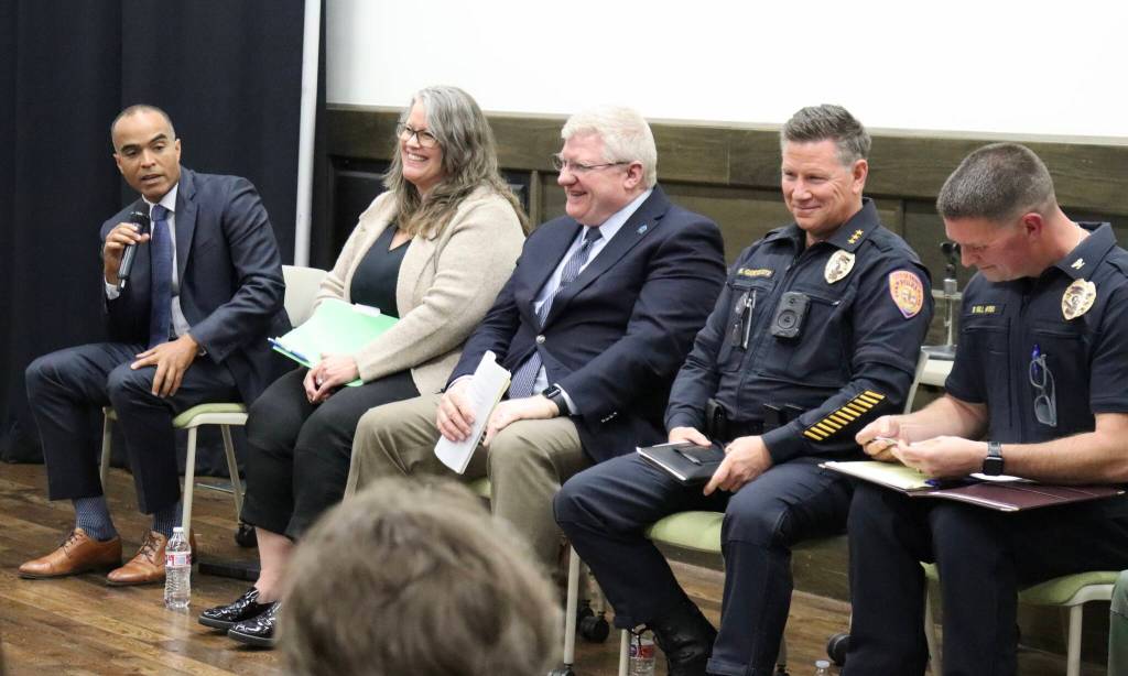 Washington Attorney General Nick Brown, left, addresses a panel of law enforcement officials and activists at Everett Community College during a public forum in Everett, Washington, discussing the state’s database for tracking police use-of-force incidents on Oct. 22, 2026. (Ian Davis-Leonard / The Daily Herald)