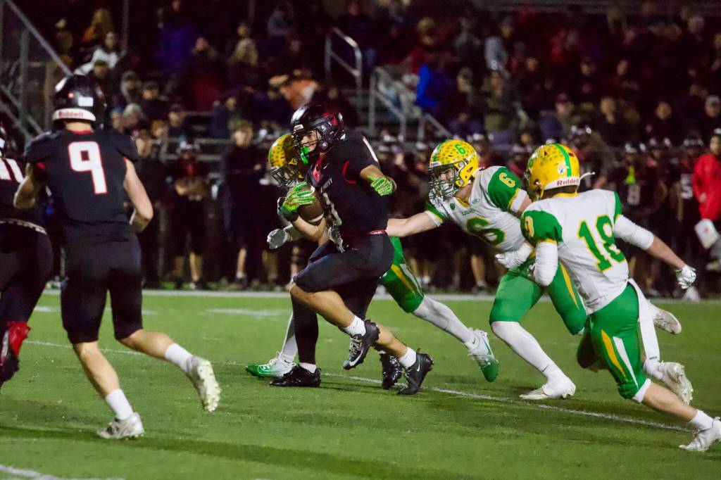 Archbishop Murphy senior Andrew Lucas evades the grasp of Lynden senior Lincoln Van Ry during the Wildcats’ 35-14 win against the Lions at Terry Ennis Stadium on Oct. 29, 2026. (Joe Pohoryles / The Herald)