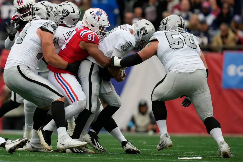 Las Vegas Raiders quarterback Kirk Cousins (8) is sacked by New England Patriots linebacker Eli ...