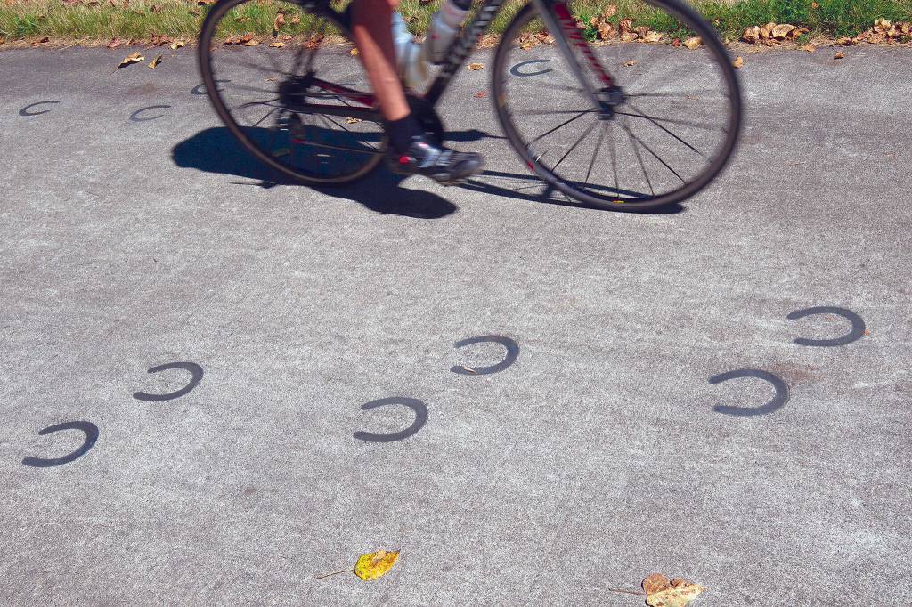 Horseshoe designs on the north end of the Centennial Trail signify the route’s dual use as an equestrian path. (Andy Bronson / The Herald)