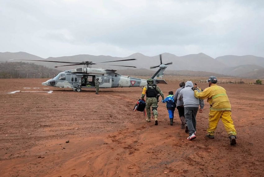 Soldiers and guardsmen on Monday rescued 32 people stranded outside Ensenada, Baja California, after a mudslide caused by Tropical Storm Rachel cut off their only escape route.