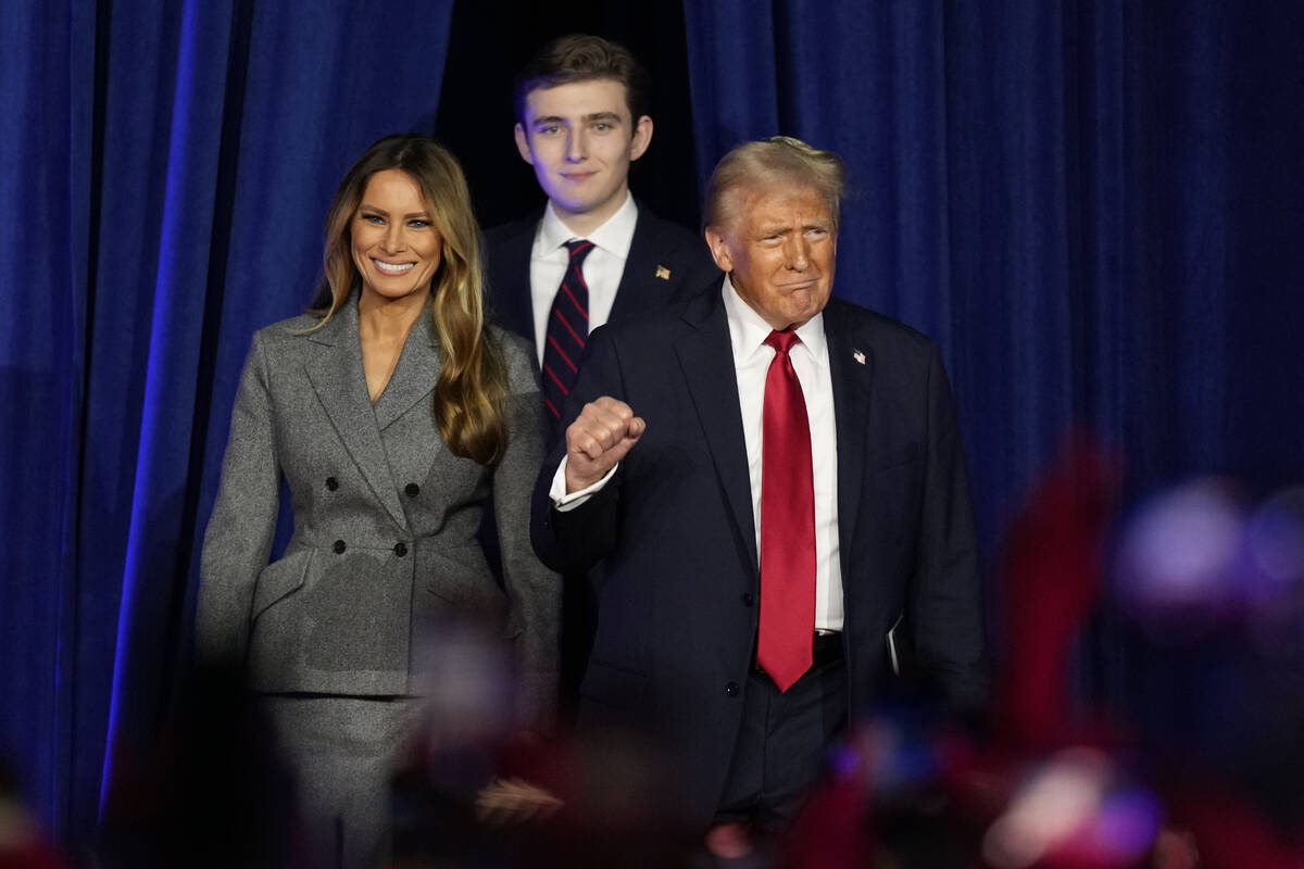 President Donald Trump, joined by Melania Trump, left, and Barron Trump. (AP Photo/Alex Brandon)