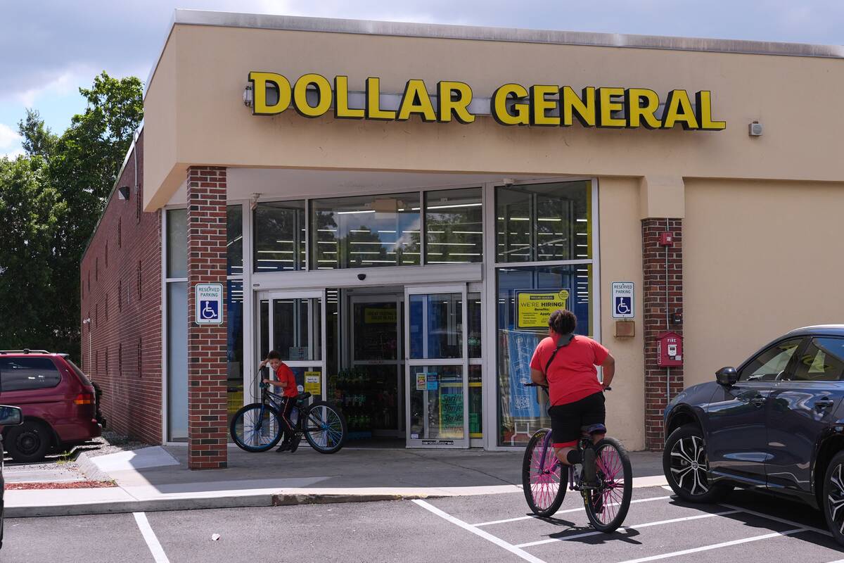 Children ride their bicycles to the Dollar General store, Aug. 21, 2025, in Nashua, N.H. (AP Ph ...