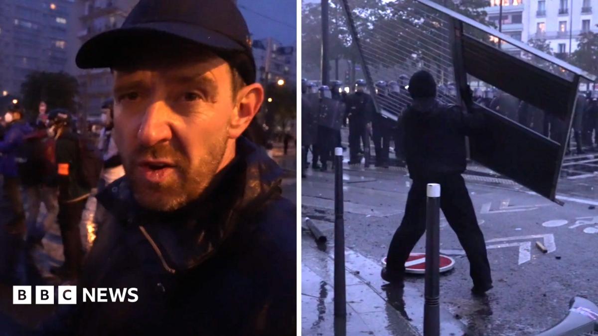 Split screen Nick Beake wears a black hat talking to the camera and a protester is about to throw a fence at police