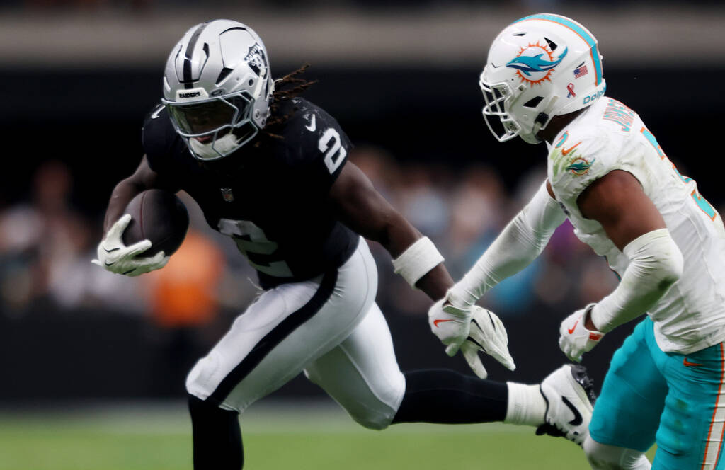 Raiders running back Ashton Jeanty (2) looks for room to run against Miami Dolphins cornerback ...