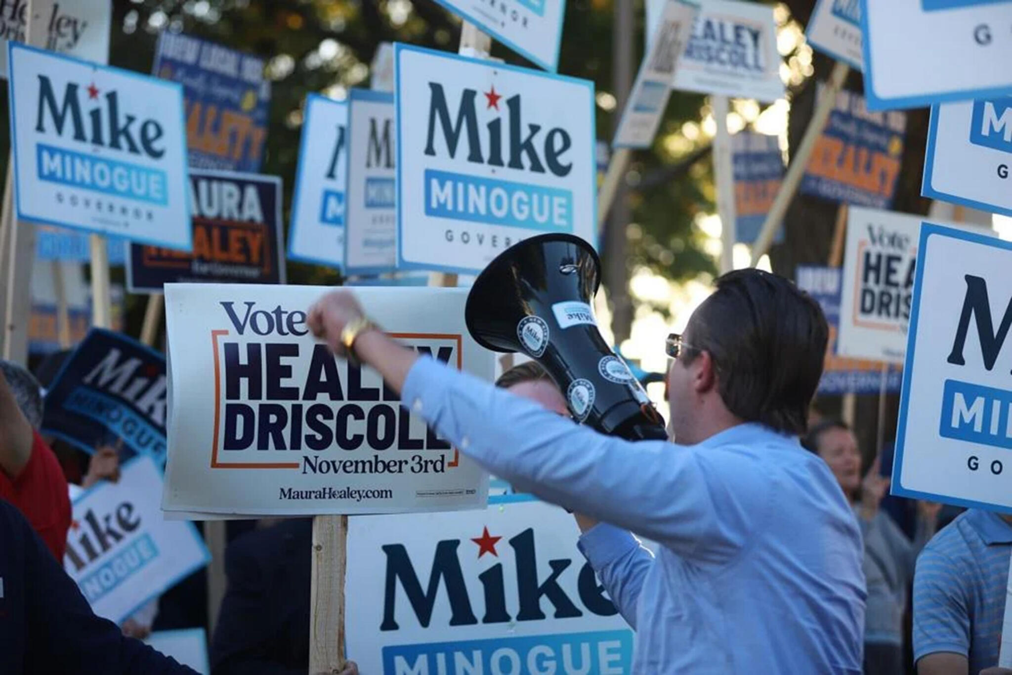 A supporter for Republican gubernatorial candidate Mike Minogue chants "Let's go Mike" to a crowd of both supporters and opponents outside of WBZ's headquarters in Boston, where Minogue and Gov. Maura Healey debated on Oct. 8. (Sam Drysdale/State House News Service)