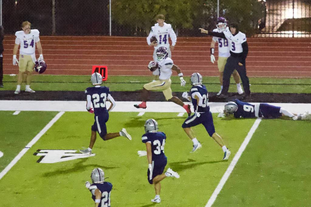 Lake Stevens senior Jayvian Ferrell churns past a slew of Glacier Peak defenders on the way to his fourth rushing touchdown of the night during the Vikings’ 55-7 win against the Grizzlies at Veterans Memorial Stadium on Oct. 9, 2026. (Joe Pohoryles / The Herald)