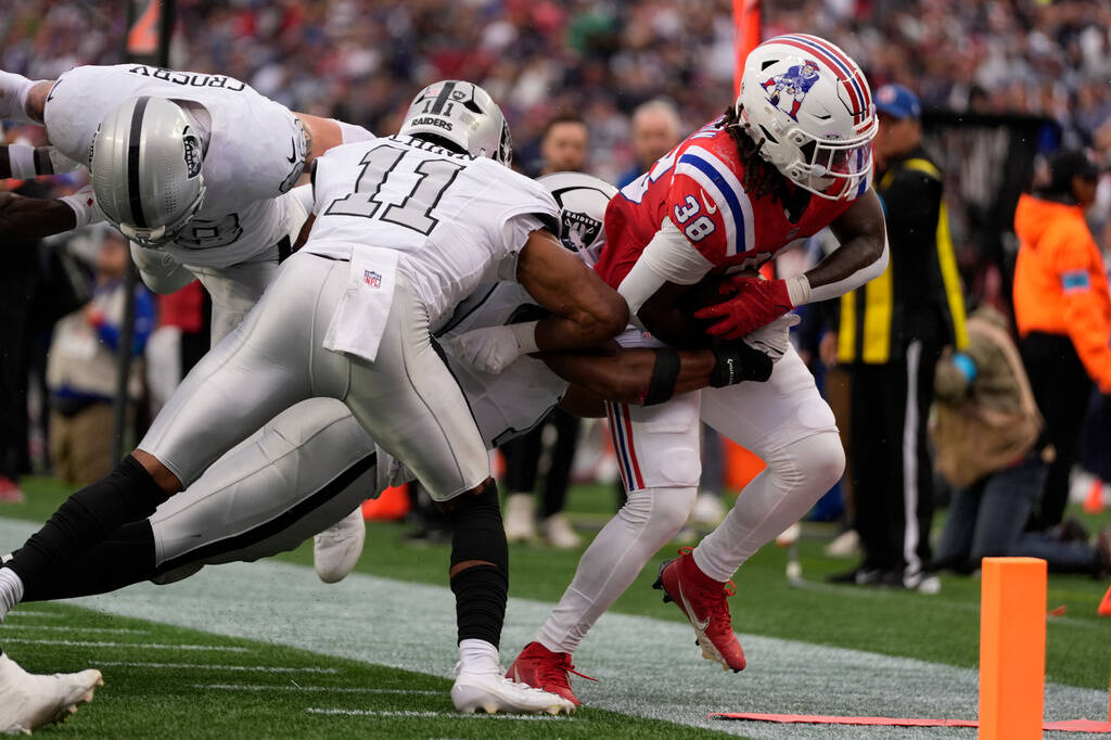 New England Patriots running back Rhamondre Stevenson (38) is stopped short of the goal line by ...