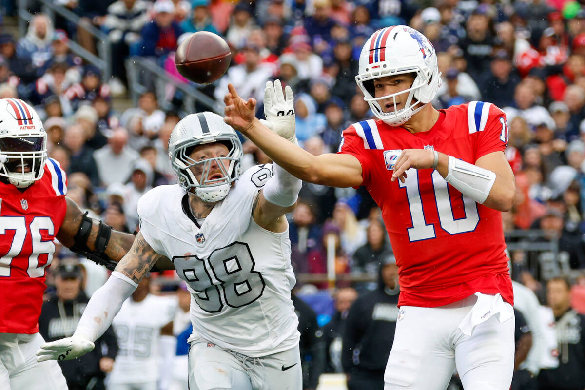 New England Patriots quarterback Drake Maye (10) makes a pass while pressured by Las Vegas Raid ...