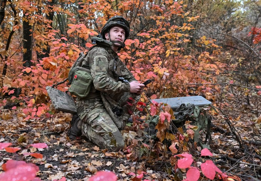 An artilleryman sets up Starlink satellite internet system near the frontline in Ukraine