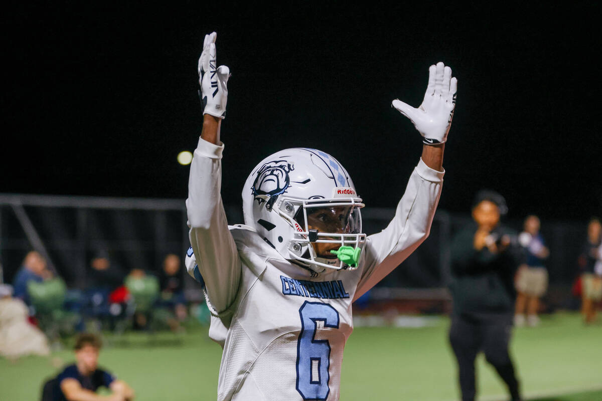 Centennial wide receiver Dervonne Sloan (6) motions for a touchdown call to the referees after ...